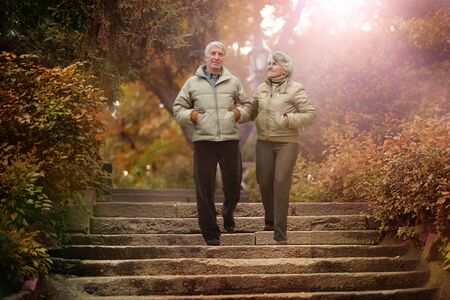 Happy senior woman and man in park