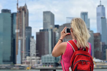 Woman taking picture New York city skylineの写真素材