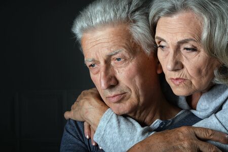 Portrait of sad senior couple posing at homeの写真素材