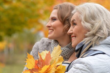 Close up portrait of senior woman with daughter restingの写真素材