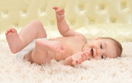Close up portrait of cute little baby girl on bed