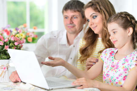 Girl with mother and father drawing at home