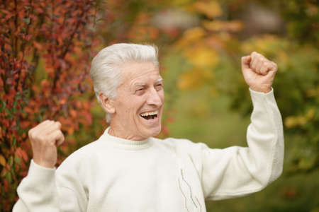 Portrait of happy senior man in park