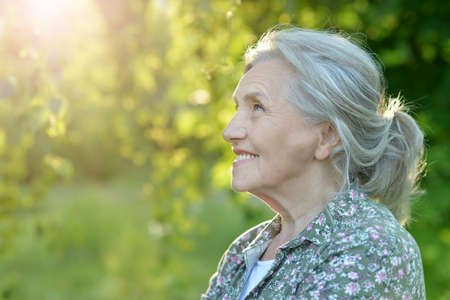 Portrait of senior beautiful woman posing in park