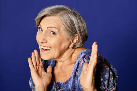 Portrait of smiling senior woman posing in studioの写真素材