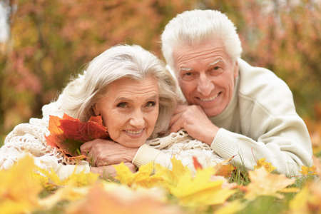 Portrait of beautiful senior couple lying on grass