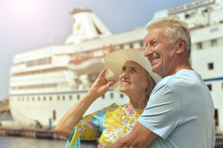 Portrait of senior couple sitting by shipの写真素材