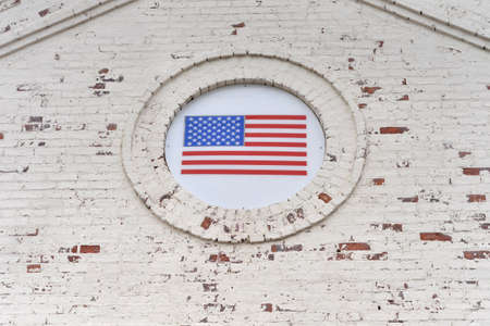 USA flag on old white brick wallの写真素材