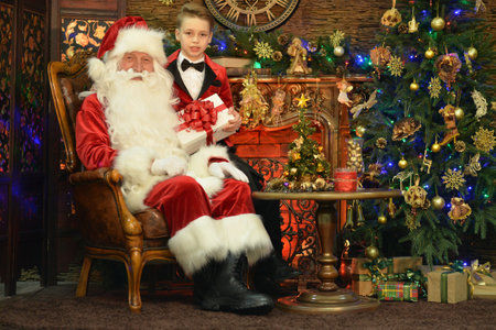 Santa Claus and happy boy with giftの写真素材
