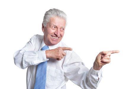 Portrait of senior businessman in formal wear pointing to the rightの写真素材