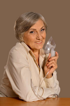 Portrait of elderly woman with flu inhalationの写真素材