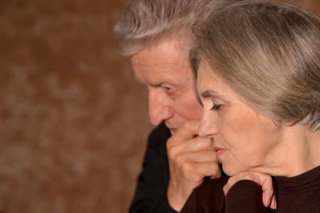 Portrait of sad senior couple posing at homeの写真素材
