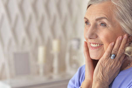Portrait of beautiful senior woman posing at home