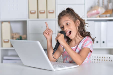 Emotional cute girl using laptop has an idea