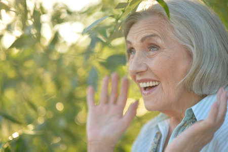 Portrait of happy smiling senior woman in parkの写真素材