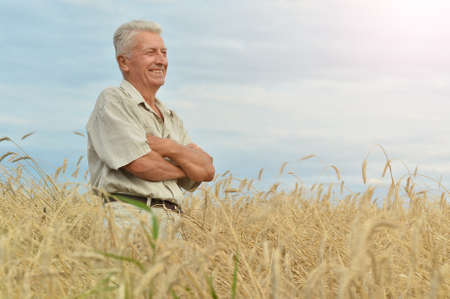 Mature man enjoying fresh air at wheat fieldの写真素材