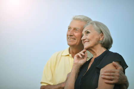 Portrait of happy senior couple embracing outdoorsの写真素材