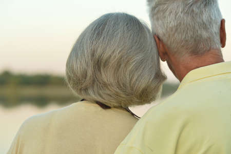 Back view. Portrait of happy elderly couple outdoorsの写真素材