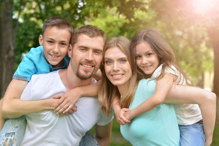 Portrait of happy young family in summer parkの写真素材