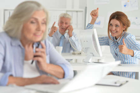 Portrait of businesspeople working in modern light officeの写真素材