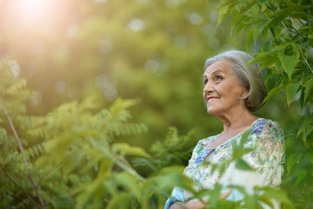 Portrait of happy smiling senior woman in park