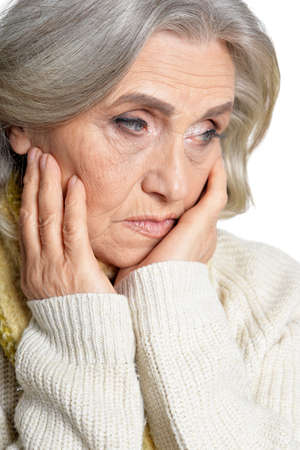 Porait of sad senior woman isolated on white background
