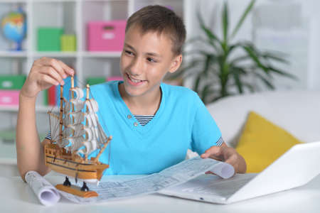 Portrait of a boy with a homemade toy-shipの写真素材