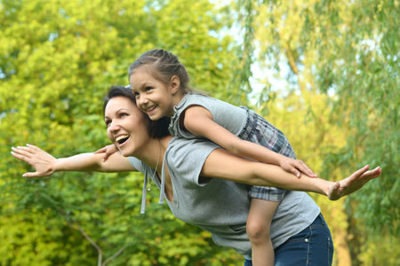 Portrait of happy mother and daughter smiling outdoorsの写真素材