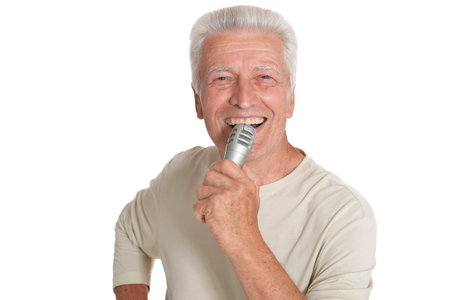 Close up portrait of senior man singing into microphoneの写真素材