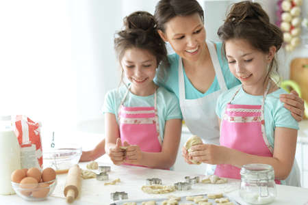 Family preparing delicious fresh salad in kitchenの写真素材