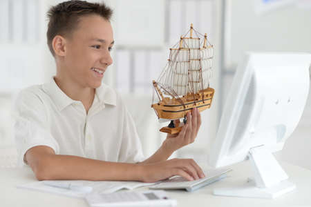 Portrait of a boy with a homemade toy-shipの写真素材