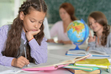 Cute girl studying in the class roomの写真素材