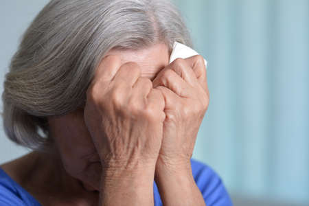 Close up portrait of sick senior womanの写真素材