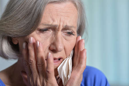 Close up portrait of sick senior womanの写真素材