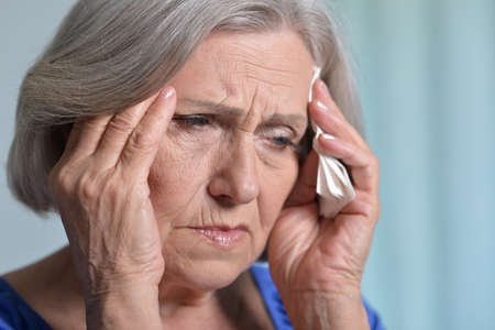 Close up portrait of sick senior woman