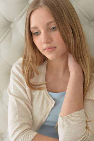 Portrait of a beautiful young girl posing at homeの写真素材