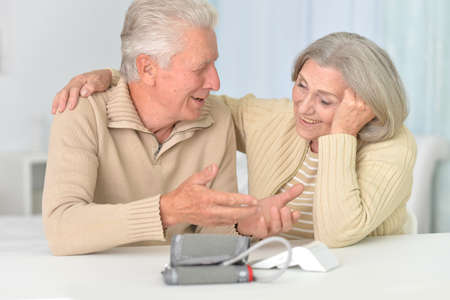 Portrait of senior couple measuring blood pressure together