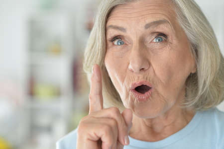 Beautiful senior woman posing at home, she has an ideaの写真素材