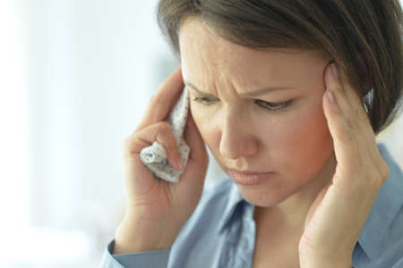 Beautiful young ill woman with headache at home