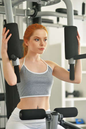 Portrait of sporty young woman training in gym