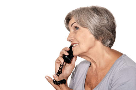 Portrait of beautiful senior woman talking on phoneの写真素材