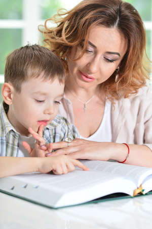 Mother with her son doing homework at home