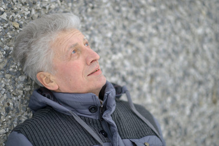 Portrait of a beautiful elderly pensive manの写真素材