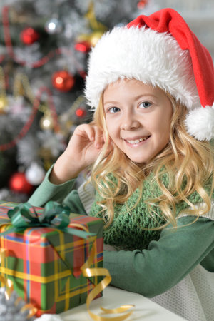 Beautiful girl sit and make decor for the new year in the roomの写真素材