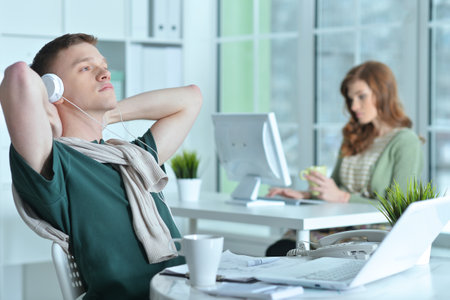 young man and woman working in officeの写真素材