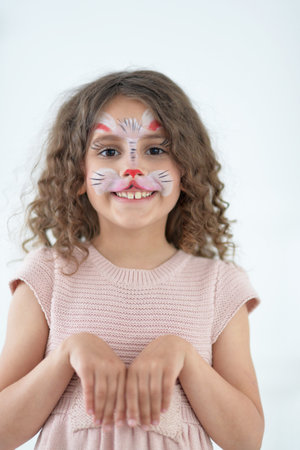 Cute little girl with face painted as rabbit
