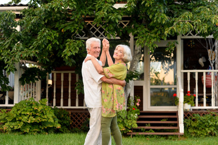 Elderly couple dancing in the apple orchardの写真素材