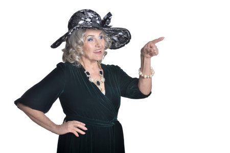 Happy gorgeous mature woman in hat showing something