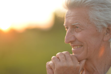 Elderly or senior man close up portrait. Happy and smiling.