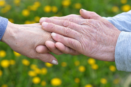 Elderly couple holding hands in autumn park